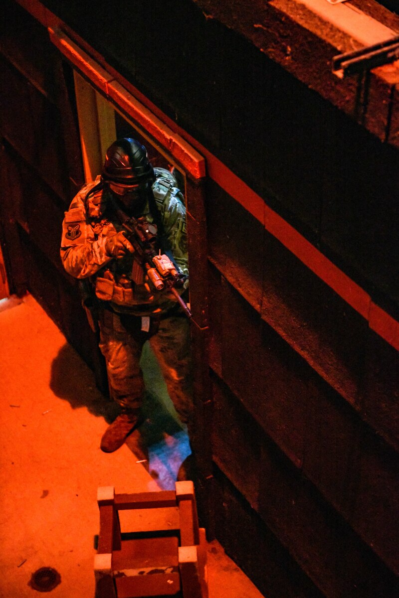 Air Force Reserve Command Defenders assigned to the 446th Security Forces Squadron, Joint Base Lewis-McChord, Washington, work their way through a live-fire training scenario, March 20, 2022, at the shoot-house at Camp James A. Garfield Joint Military Training Center, Ohio.