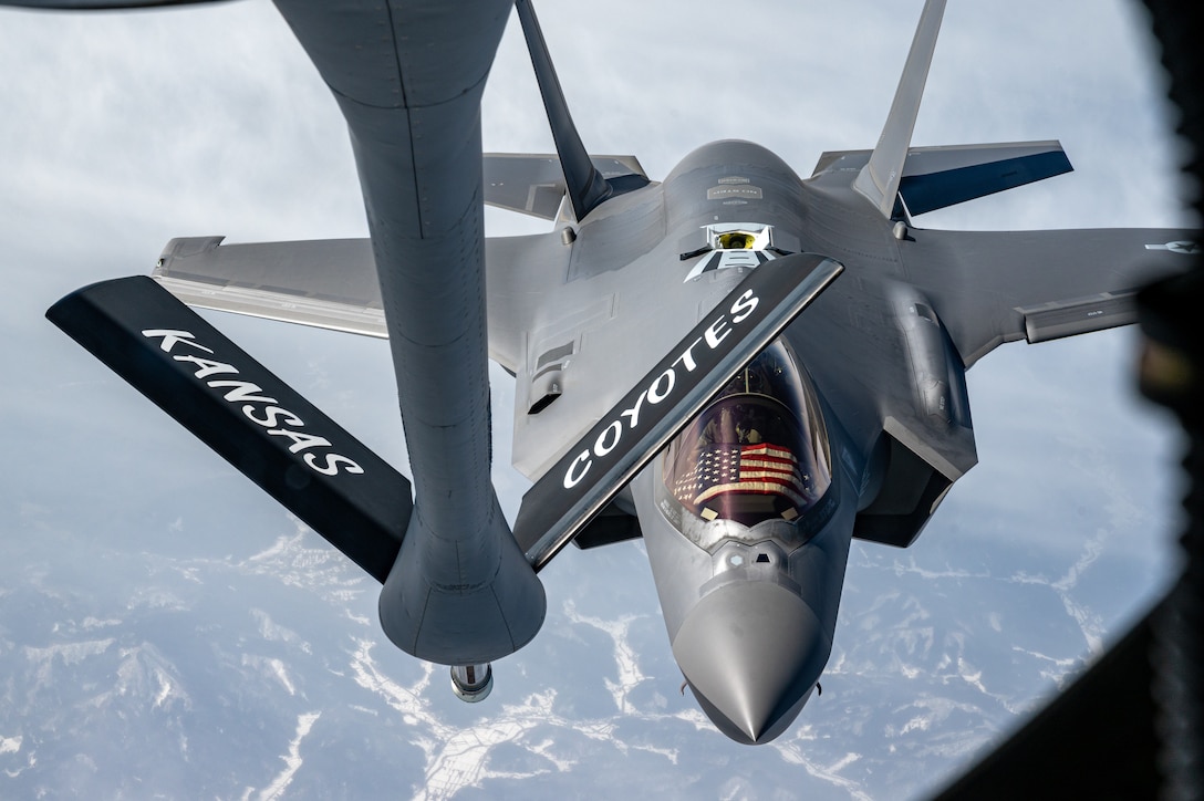A fighter aircraft approaches another aircraft for refueling.