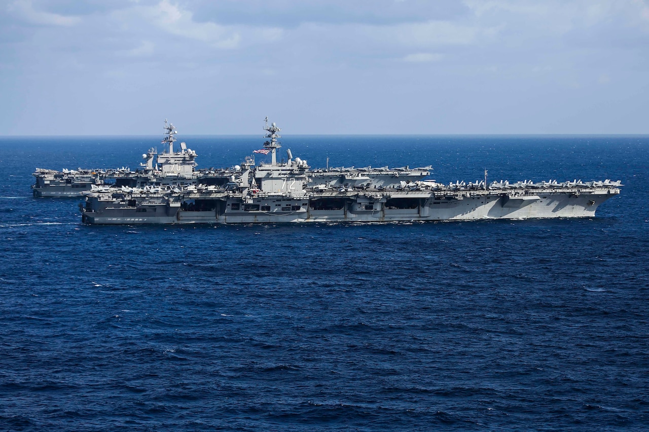 Two aircraft carriers sail together in the Pacific.