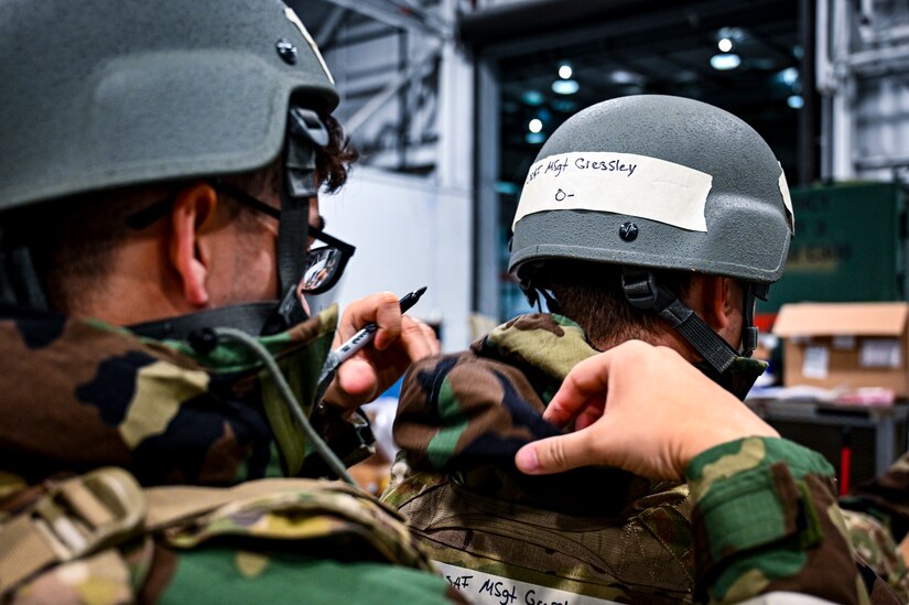 A U.S. Air Force Airman from the 305th Air Mobility Wing labels tape on mission oriented protective posture gear, demonstrating the ability to survive and operate in a contested environment during a readiness exercise at Joint Base McGuire-Dix-Lakehurst, New Jersey, Apr. 3, 2022. Training exercises reinforce Airmen readiness and deliberately strengthen Air Mobility Command’s warfighting culture in order to provide unrivaled Rapid Global Mobility capable of protecting and sustaining the Joint Force.