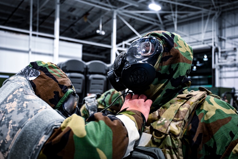 A U.S. Air Force Airman from the 305th Air Mobility Wing inspects a mission oriented protective posture gear protective mask seal, demonstrating the ability to survive and operate in a contested environment during a readiness exercise at Joint Base McGuire-Dix-Lakehurst, New Jersey, Apr. 3, 2022. Training exercises reinforce Airmen readiness and deliberately strengthen Air Mobility Command’s warfighting culture in order to provide unrivaled Rapid Global Mobility capable of protecting and sustaining the Joint Force.