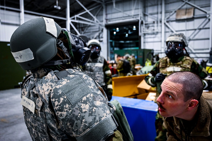 A U.S. Air Force Airman from the 305th Air Mobility Wing inspects mission oriented protective posture gear, demonstrating the ability to survive and operate in a contested environment during a readiness exercise at Joint Base McGuire-Dix-Lakehurst, New Jersey, Apr. 3, 2022. Training exercises reinforce Airmen readiness and deliberately strengthen Air Mobility Command’s warfighting culture in order to provide unrivaled Rapid Global Mobility capable of protecting and sustaining the Joint Force.