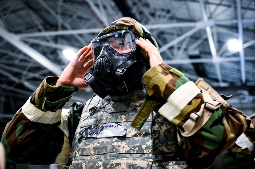 A U.S. Air Force Airman from the 514th Air Mobility Wing tests the seal of a mission oriented protective posture gear protective mask, demonstrating the ability to survive and operate in a contested environment during a readiness exercise at Joint Base McGuire-Dix-Lakehurst, New Jersey, Apr. 3, 2022. Training exercises reinforce Airmen readiness and deliberately strengthen Air Mobility Command’s warfighting culture in order to provide unrivaled Rapid Global Mobility capable of protecting and sustaining the Joint Force.