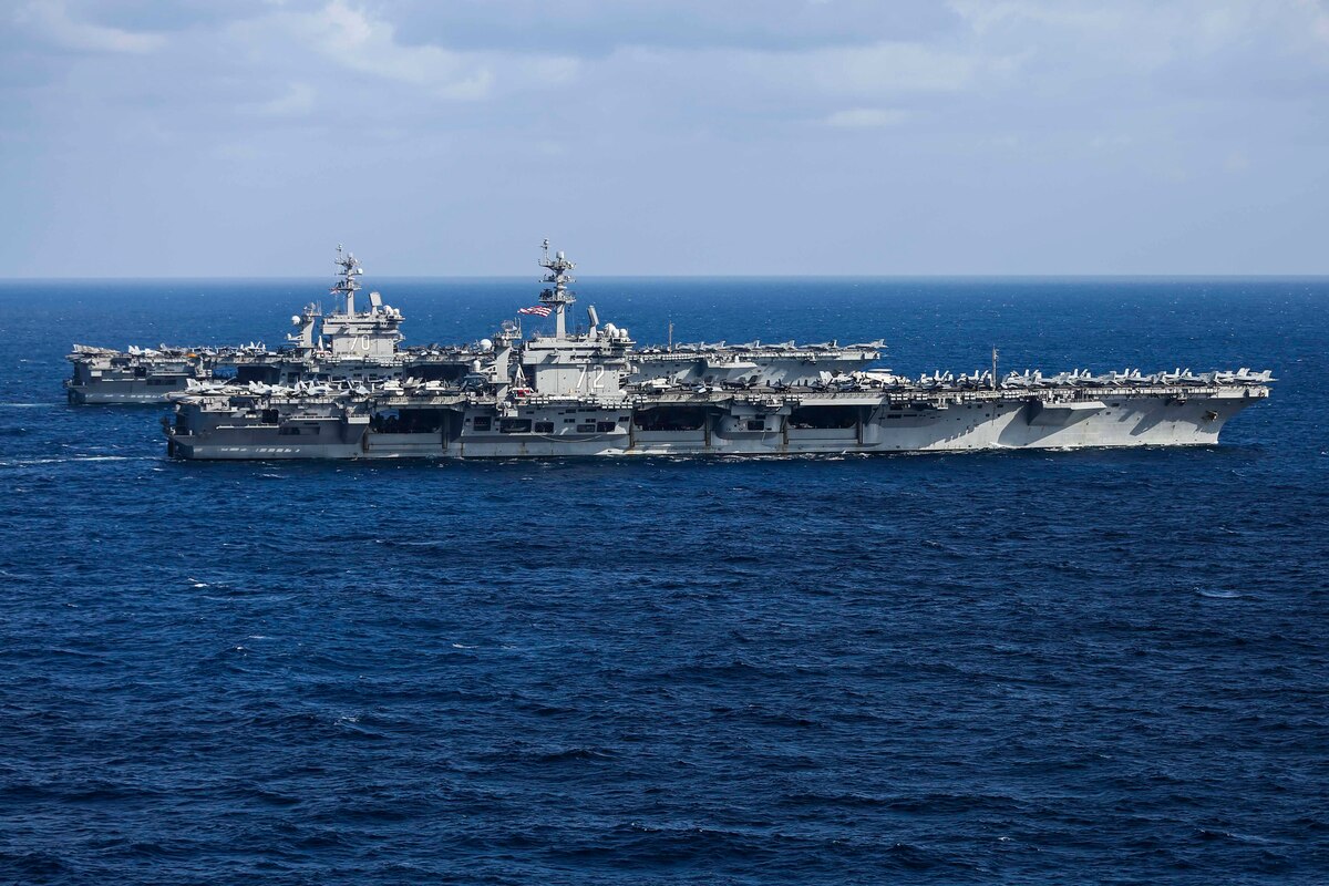 Two aircraft carriers sail together in the Pacific.