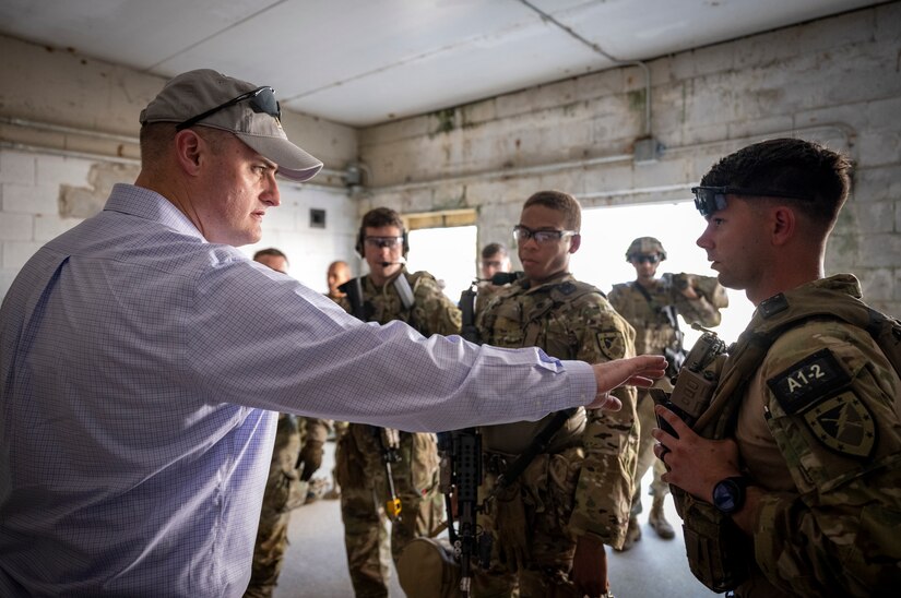 Raymond Fields, operational lead for Project INCISIVE, assists Soldiers with their Nett Warrior end user devices during an Army Expeditionary Warrior Experiment (AEWE) force-on-force field demonstration held on Fort Benning, March 3. The demonstration at the AEWE event showcased the practical application of the Soldier-Borne Sensor, Nett Warrior and artificial intelligence working in tandem to enhance the situational awareness of the Soldier.