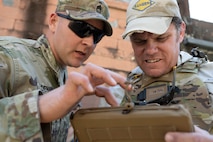 Master Sgt. Trevor Denny, senior enlisted advisor for Project Director Soldier and Squad Integration and Brian Martin, an instructor for PEO Soldier, observe actions through the Soldier-Borne Sensor during an Army Expeditionary Warrior Experiment (AEWE) force-on-force field demonstration held on Fort Benning, March 3. The demonstration at the AEWE event showcased the practical application of the SBS, Nett Warrior and artificial intelligence working in tandem to enhance the situational awareness of the Soldier.