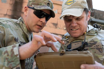 Master Sgt. Trevor Denny, senior enlisted advisor for Project Director Soldier and Squad Integration and Brian Martin, an instructor for PEO Soldier, observe actions through the Soldier-Borne Sensor during an Army Expeditionary Warrior Experiment (AEWE) force-on-force field demonstration held on Fort Benning, March 3. The demonstration at the AEWE event showcased the practical application of the SBS, Nett Warrior and artificial intelligence working in tandem to enhance the situational awareness of the Soldier.