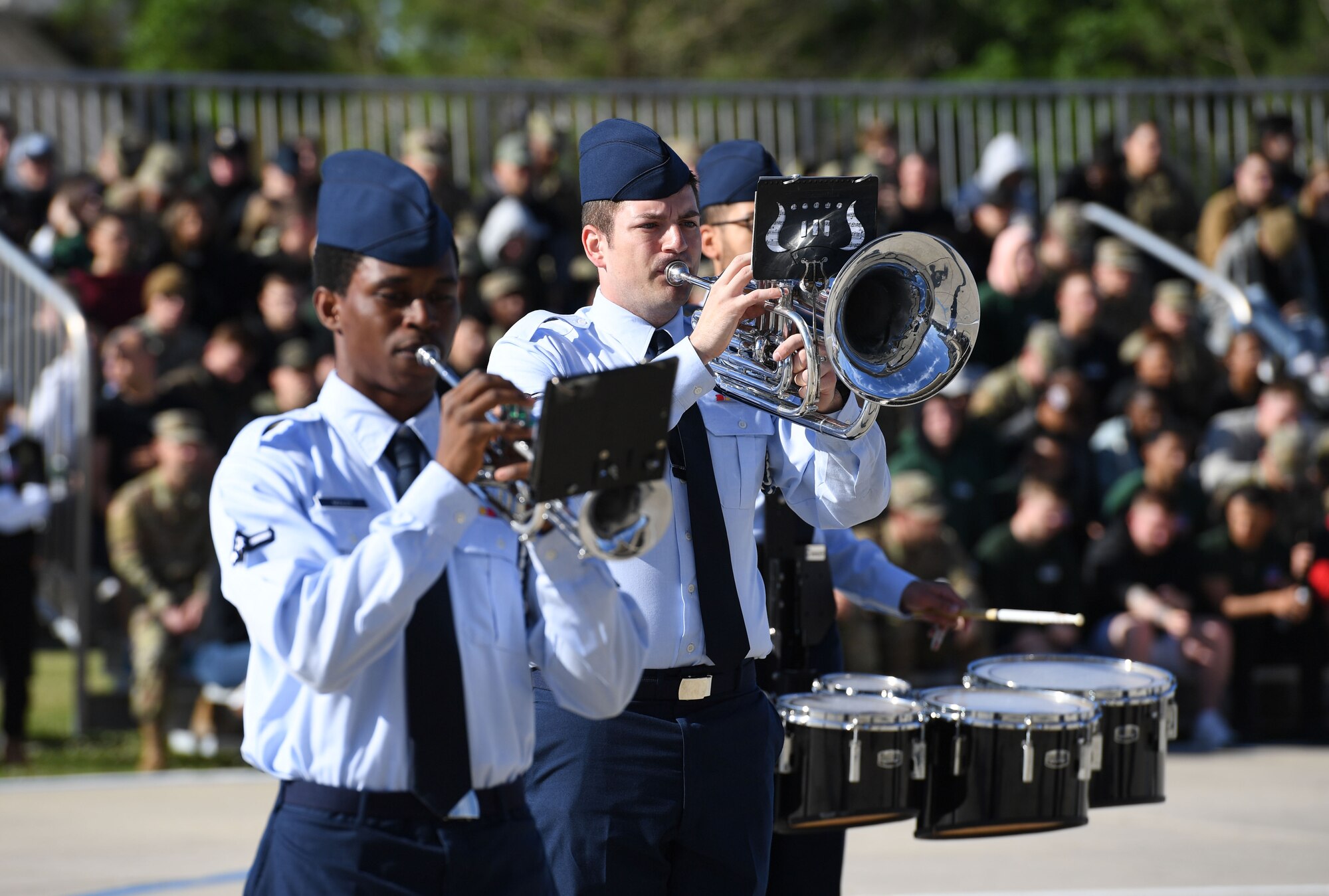 Members of the 81st Training Group Drum and Bugle Corps performs during the 81st TRG drill down on the Levitow Training Support Facility drill pad at Keesler Air Force Base, Mississippi, April 1, 2022. Keesler trains more than 30,000 students each year. While in training, Airmen are given the opportunity to volunteer to learn and execute drill down routines. (U.S. Air Force photo by Kemberly Groue)