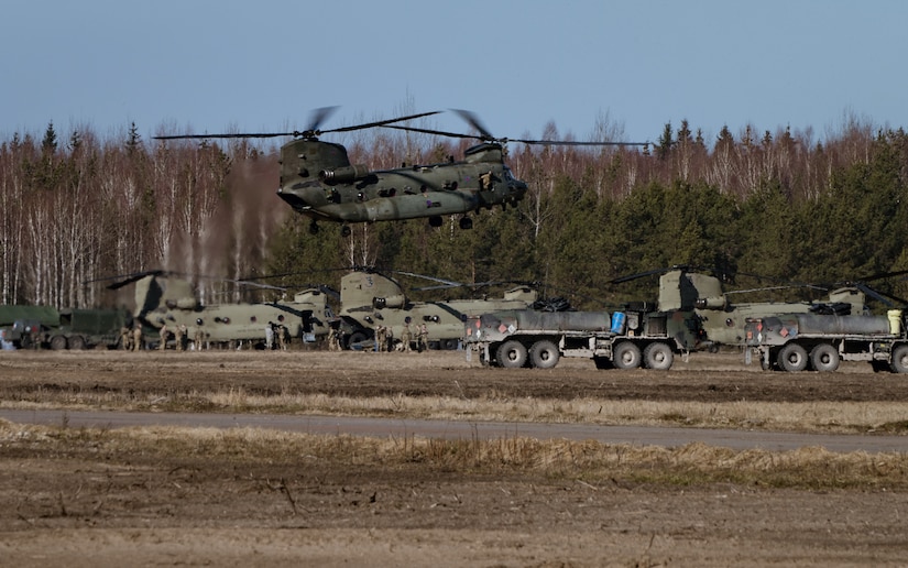 Helicopter hovers over a landing zone in Latvia.