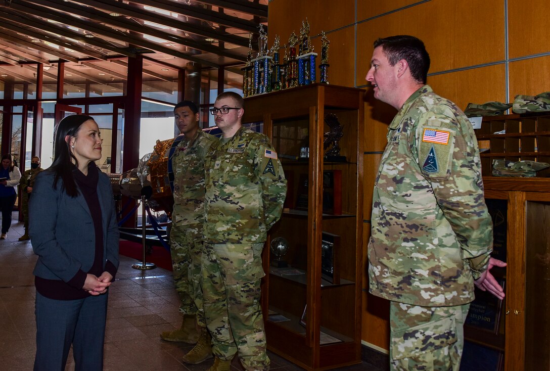 Space Delta 4 members receive challenge coins from the Honorable Gina Ortiz Jones, Under Secretary of the Air Force, for their exemplary work at the Mission Control Station lobby on Buckley Space Force Base, Colo., April 4, 2022.