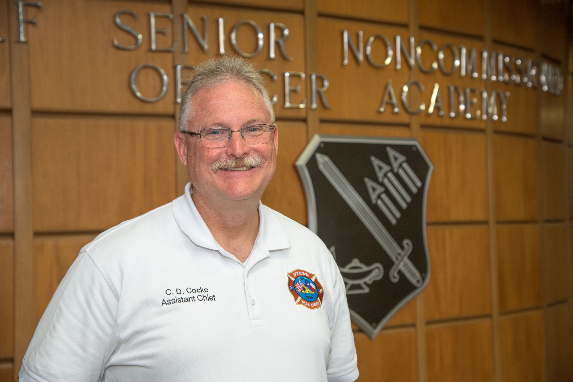 Mr. Christopher Cocke becomes the first civilian to graduate from the Senior Non-Commissioned Officer Academy. (U.S. Air Force photo by Trey Ward)