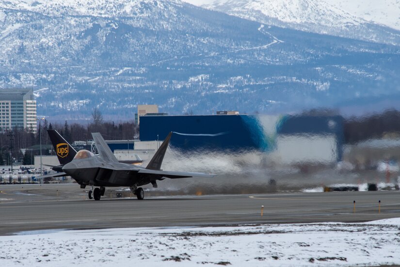 A photo of an F-22 Raptor taking off from Ted Stevens Anchorage International Airport.