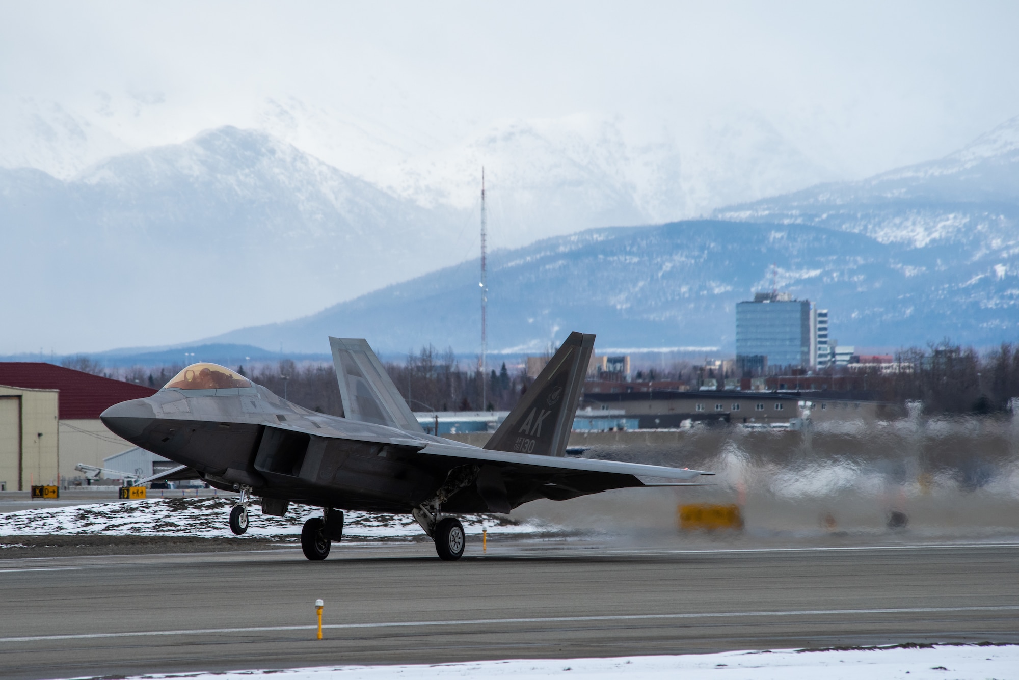 A photo of an F-22 Raptor taking off from Ted Stevens Anchorage International Airport.