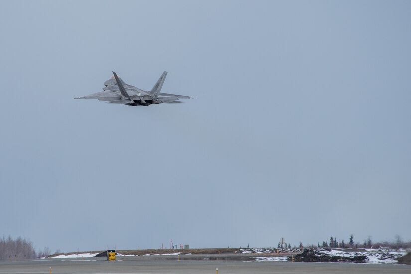 A photo of an F-22 Raptor taking off from Ted Stevens Anchorage International Airport.