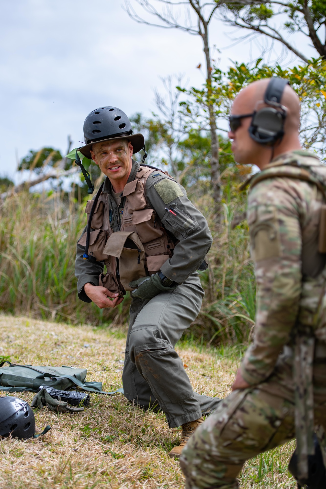 Two airmen share a laugh while they wait for a helicopter