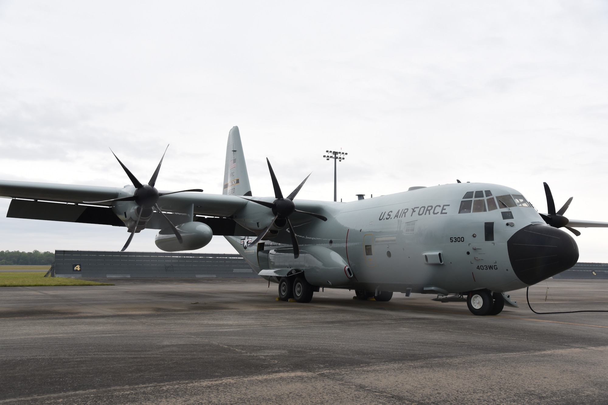 WC-130J Super Hercules with new shiny gray paint scheme and vintage markings.