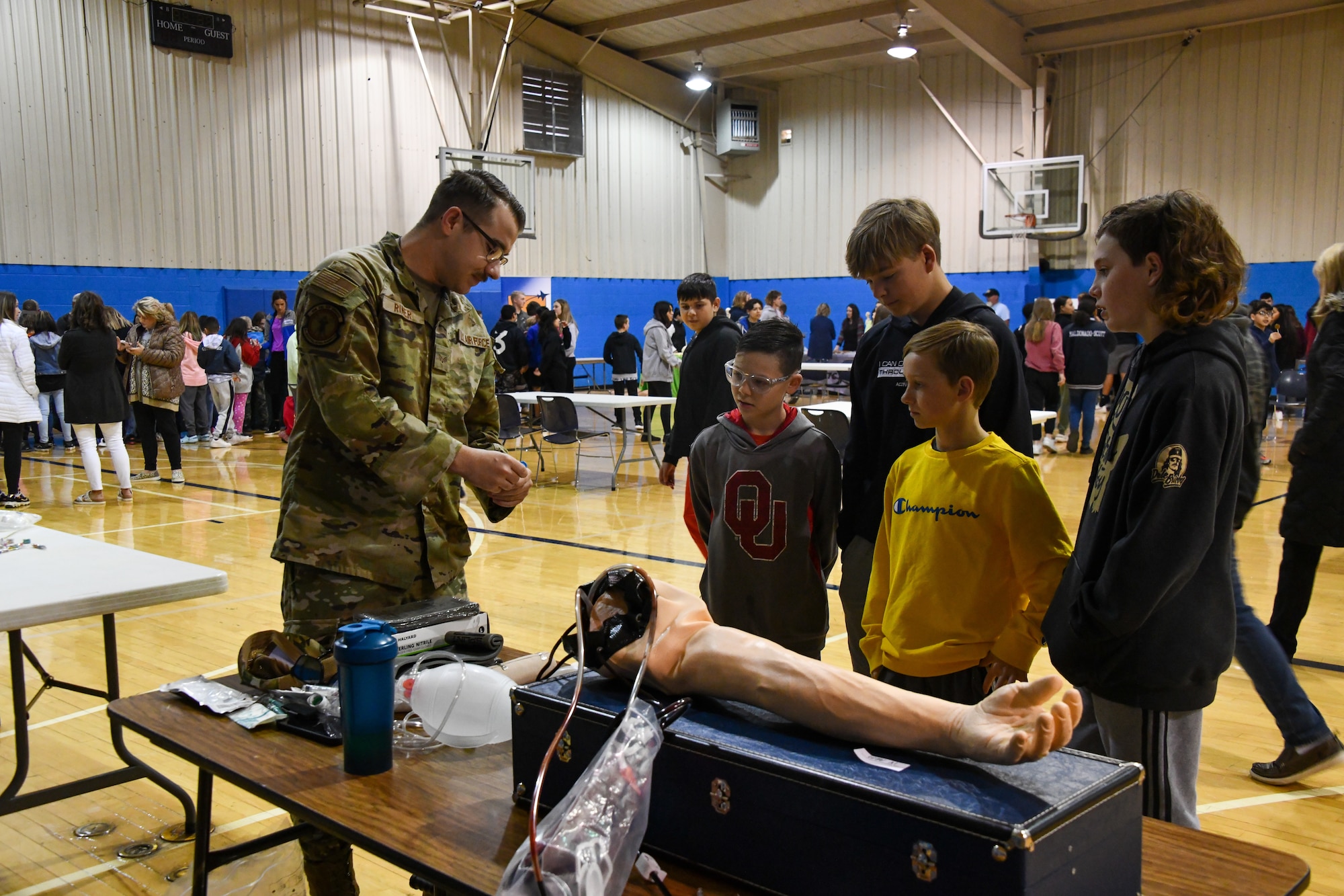 Senior Airman Taylor Riner, 97th Medical Group family practice medical technician, demonstrates how to use an epinephrine pen to a group of students from Altus Junior High School at Altus High School, Altus, Oklahoma, March 30, 2022. Riner’s display showed phlebotomy, injections and more. (U.S. Air Force photo by Airman 1st Class Miyah Gray)