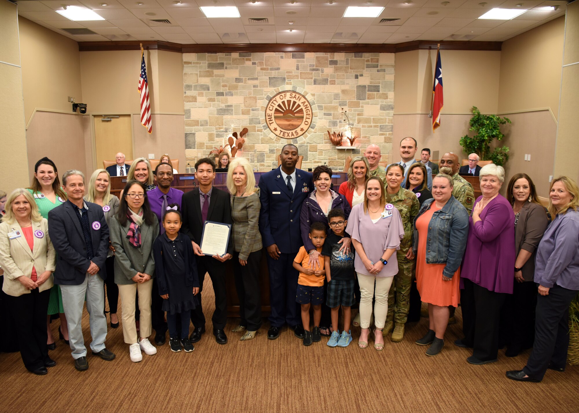Brenda Gunter, City of San Angelo mayor, poses with members of San Angelo Independent School District and Goodfellow Air Force Base at the McNease Convention Center, San Angelo, Texas, April 5, 2022. Gunter declared April as the Month of the Military Child in San Angelo during a city council meeting. (U.S. Air Force photo by Senior Airman Ethan Sherwood)
