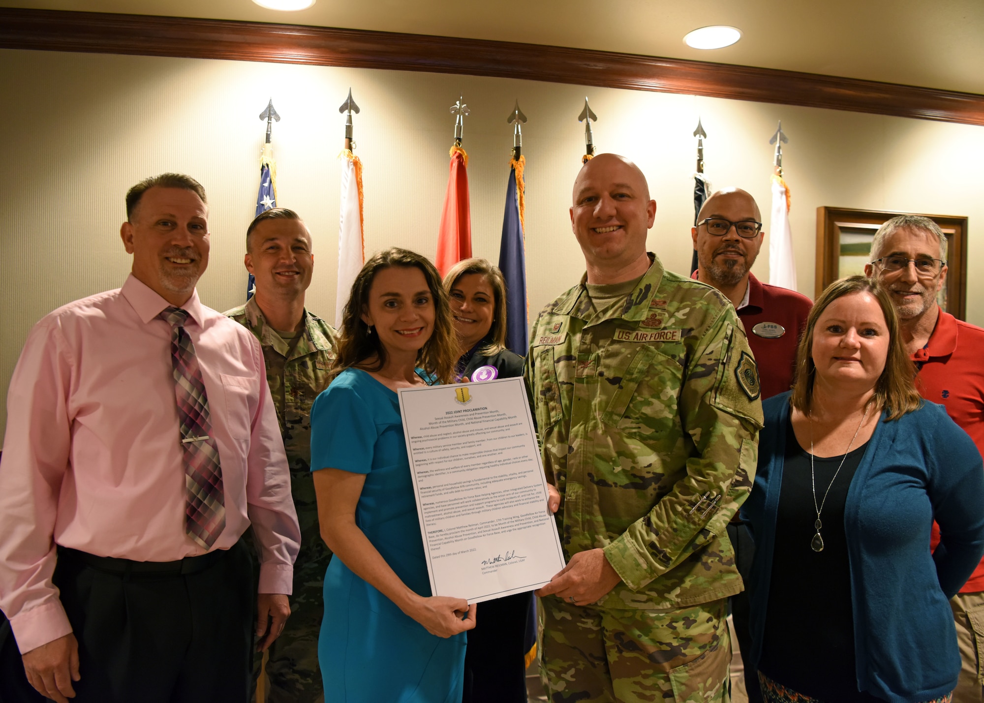 U.S. Air Force Col. Matthew Reilman, 17th Training Wing commander, and representatives of 17th TRW helping agencies pose with the joint proclamation at Goodfellow Air Force Base, Texas, April 5, 2022. Reilman worked with multiple agencies to recognize many observances during April. (U.S. Air Force photo by Senior Airman Ethan Sherwood)