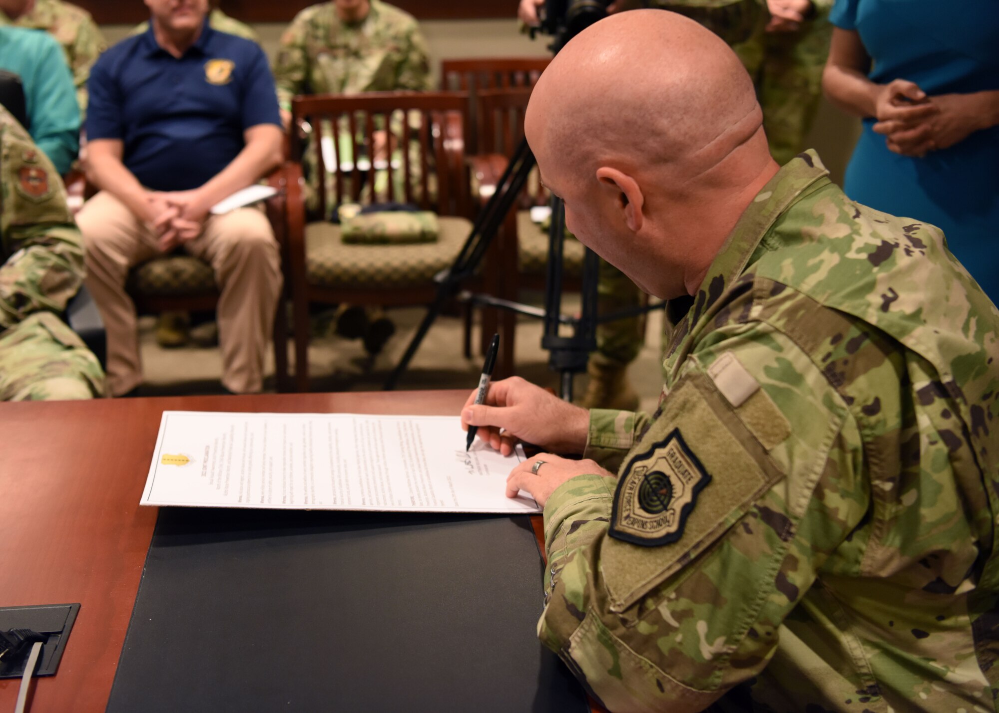 U.S. Air Force Col. Matthew Reilman, 17th Training Wing commander, signs a joint proclamation to recognize multiple observances for April at Goodfellow Air Force Base, Texas, April 5, 2022. Reilman declared April the Month of the Military Child, Child Abuse Prevention Month, Sexual Assault Prevention Month, Financial Capability Month, and Alcohol Awareness Month. (U.S. Air Force photo by Senior Airman Ethan Sherwood)