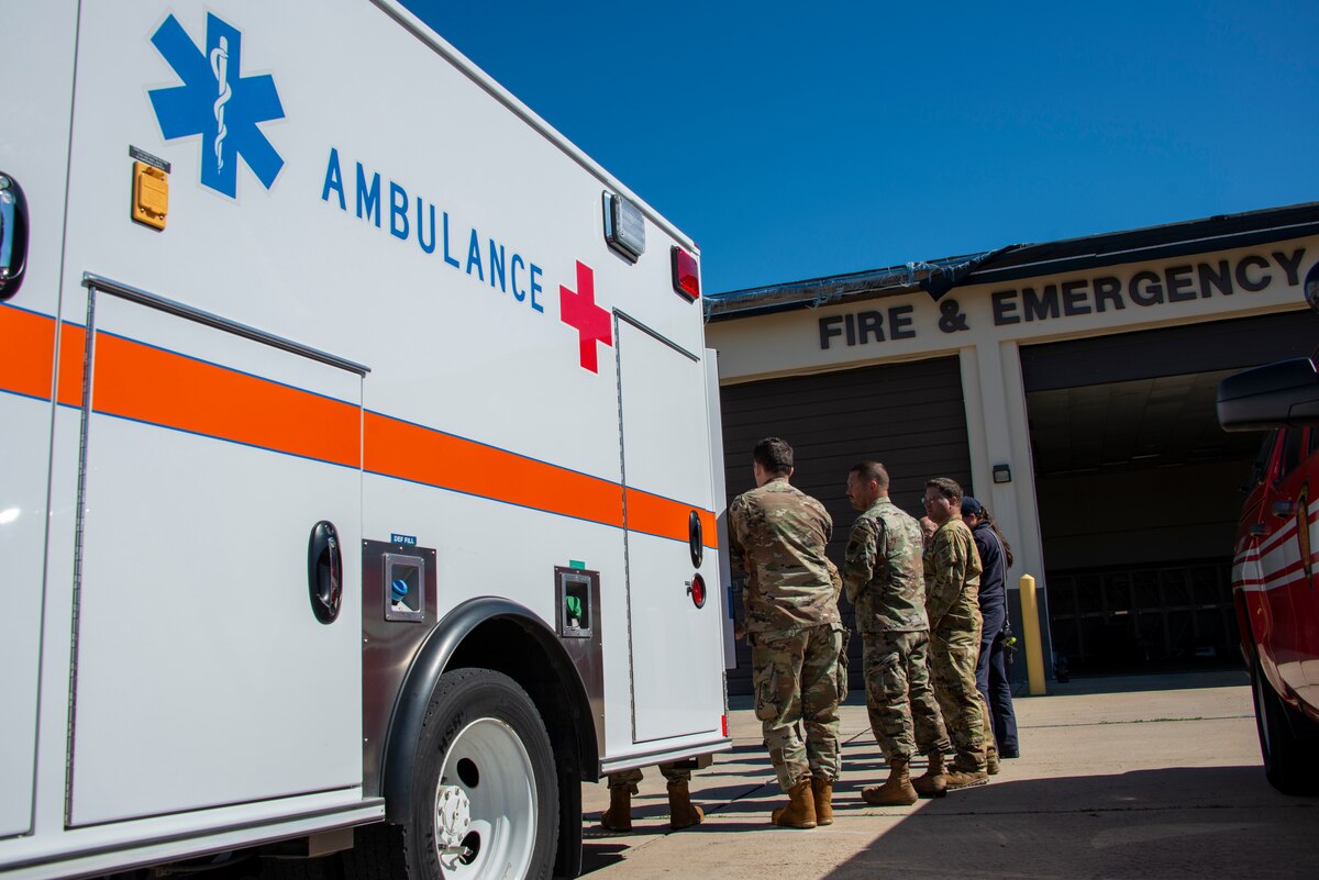 ambulance and Airman outside a fire station