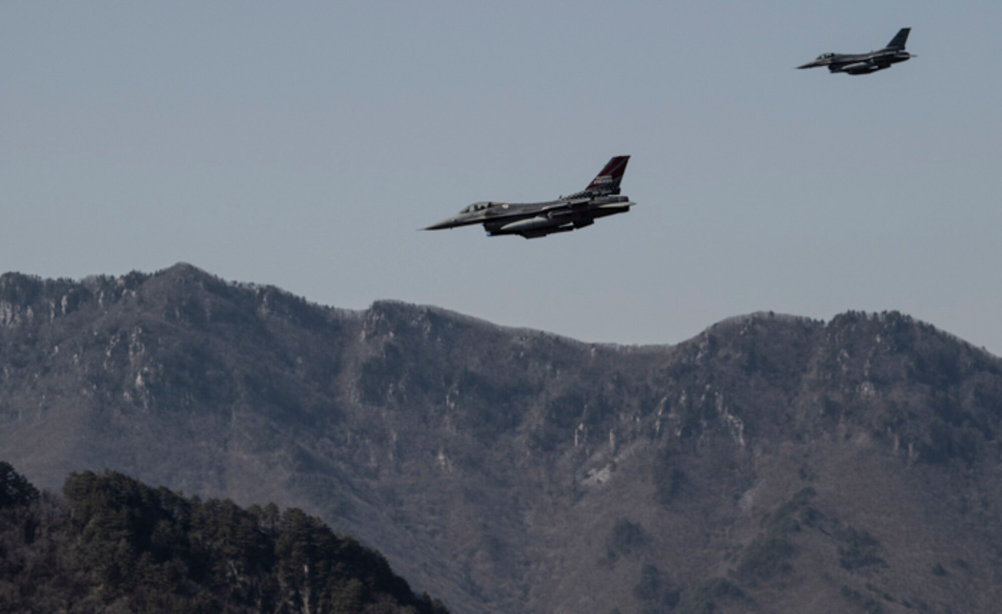 Two F-16 Fighting Falcons approach a target during a Combat Search and Rescue (CSARTE) at the Pilsung Range, Republic of Korea, March 29, 2022.