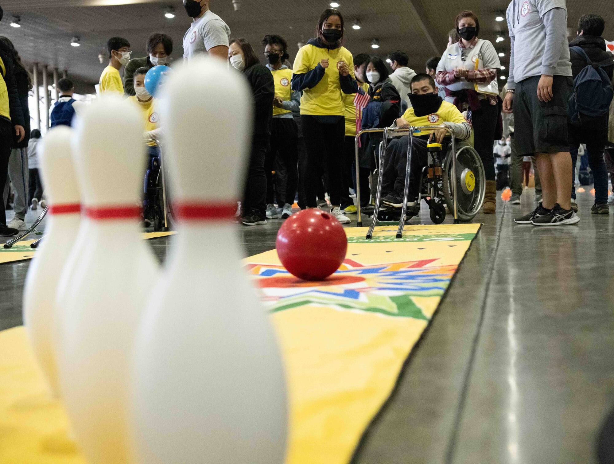 An athlete of the 2022 Misawa Special Olympics rolls a bowling ball during one of the games.