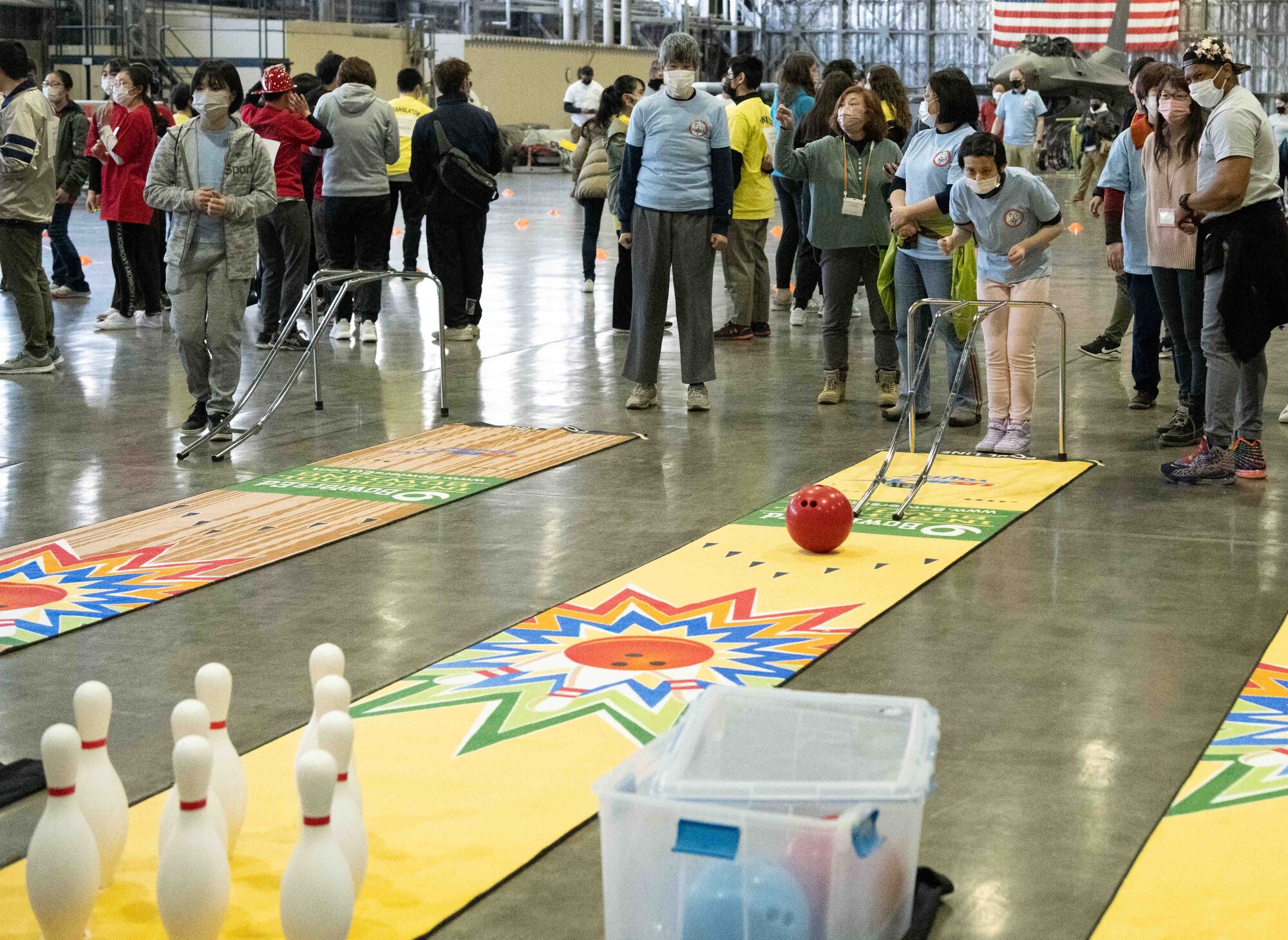 An athlete of the 2022 Misawa Special Olympics rolls a bowling ball during one of the games.