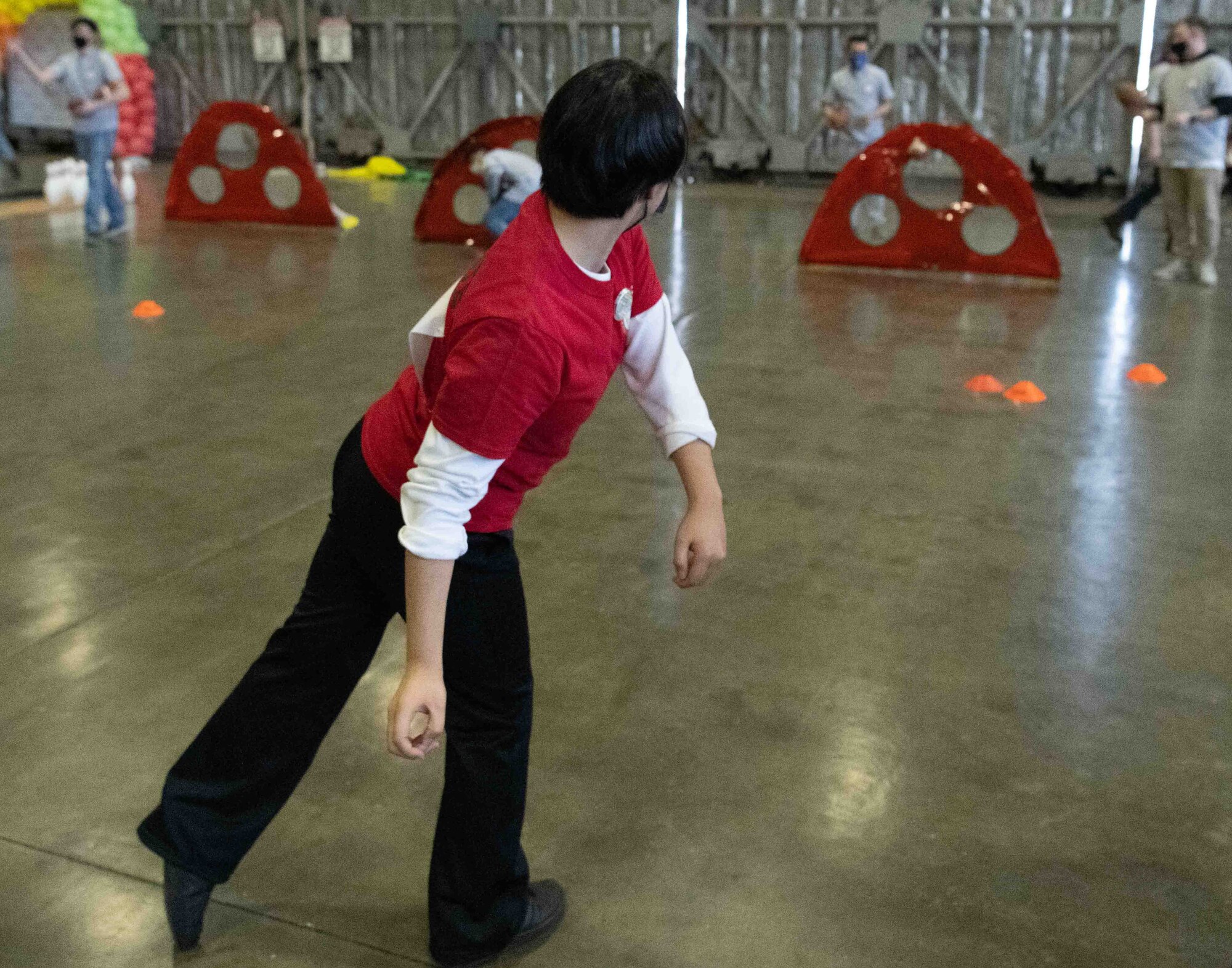 An athlete of the 2022 Misawa Special Olympics throws a football into a goal during one of the games.