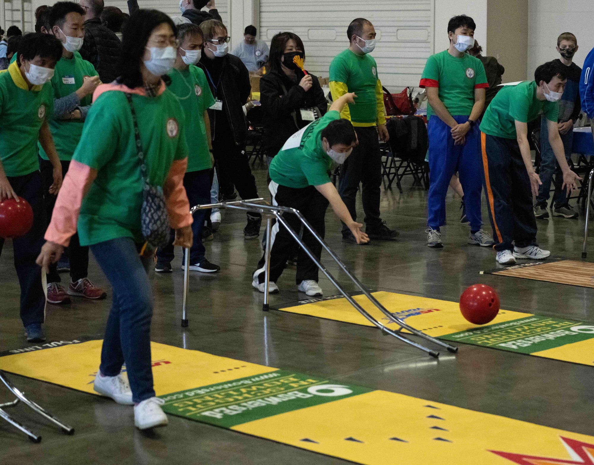 An athlete of the 2022 Misawa Special Olympics rolls a bowling ball during one of the games.