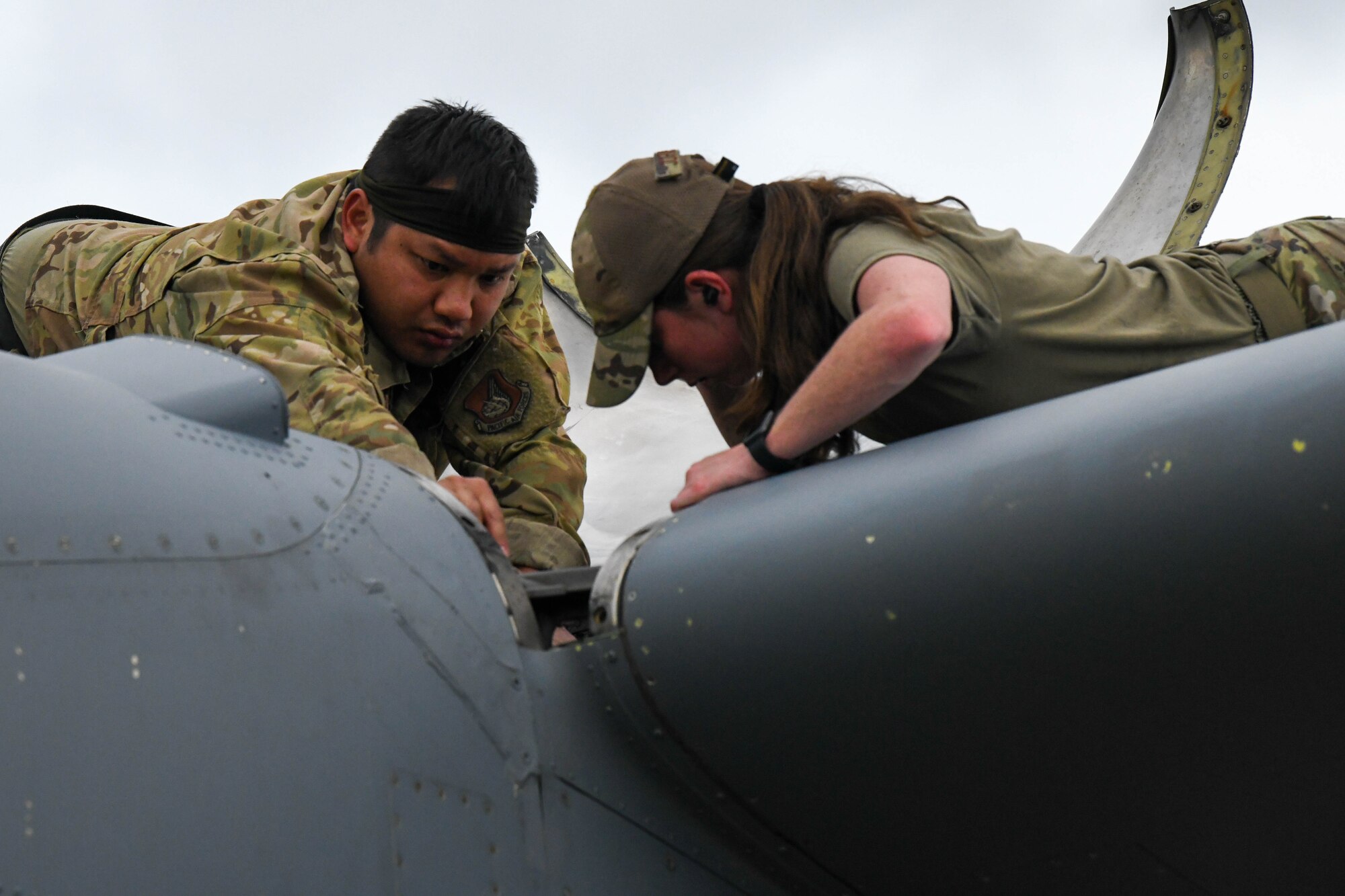 Airmen work to repair a C-130J engine