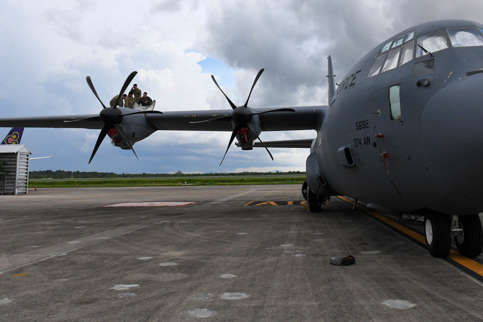 Airmen inspect a C-130J Super Hercules engine