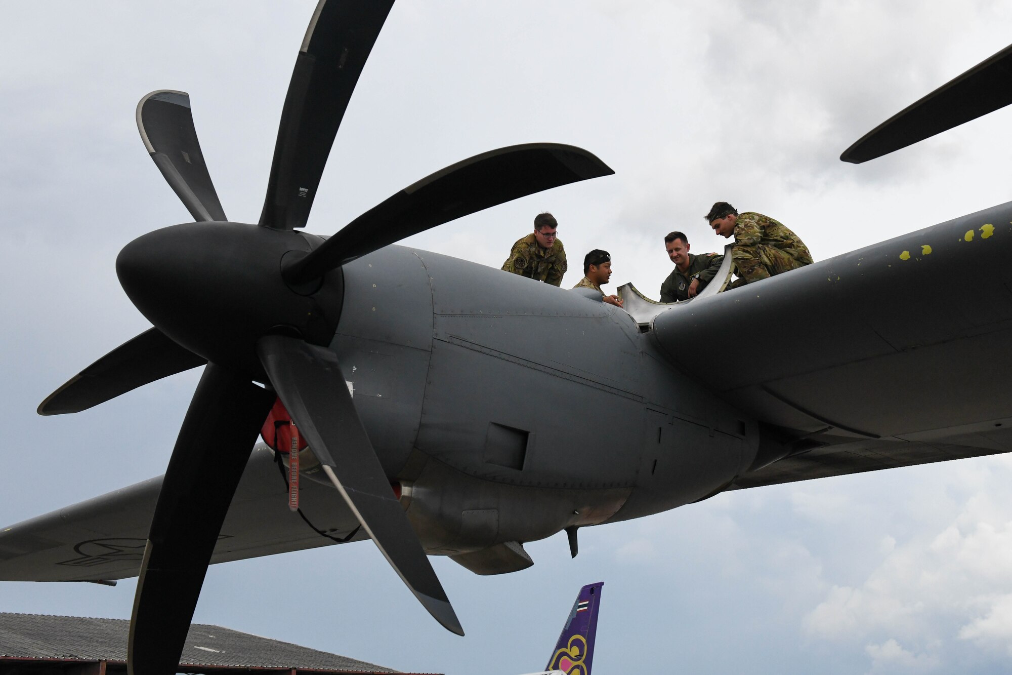 Airmen inspect a C-130J Super Hercules engine