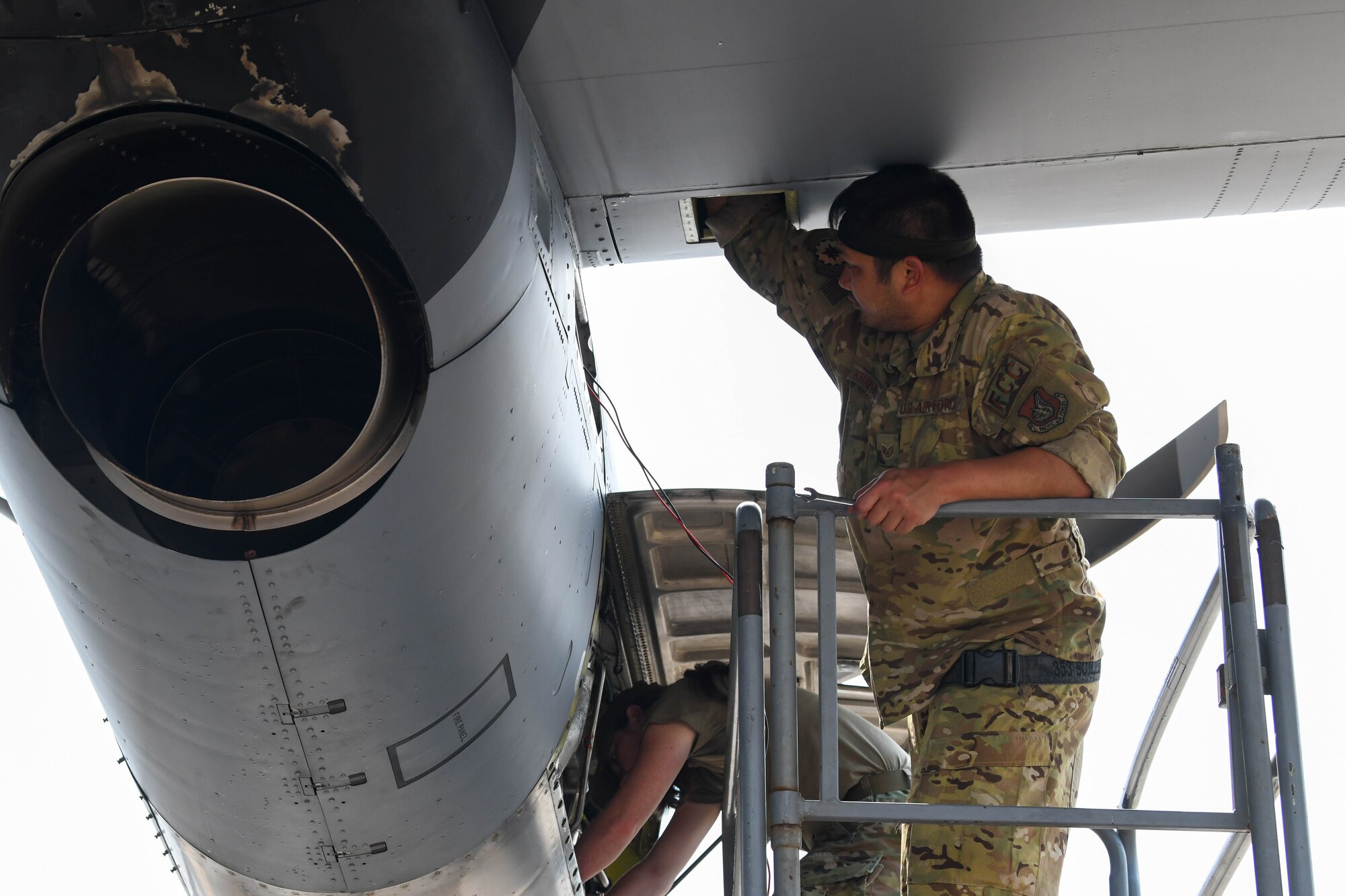 Airmen work to repair a C-130J engine