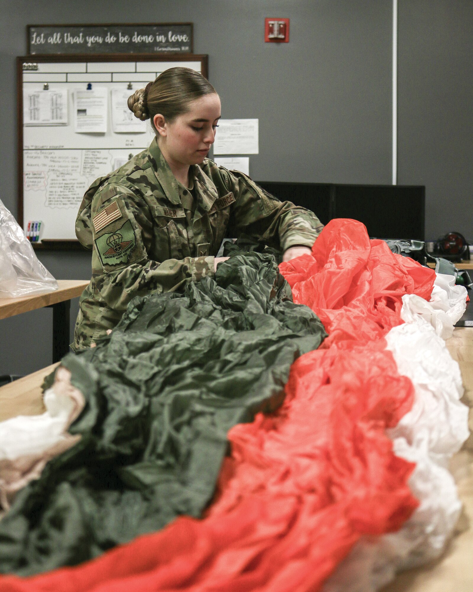 Senior Airman Sarah Maher, 445th Operations Support Squadron aircrew flight equipment technician, inspects a parachute for any defects, March 14, 2022.