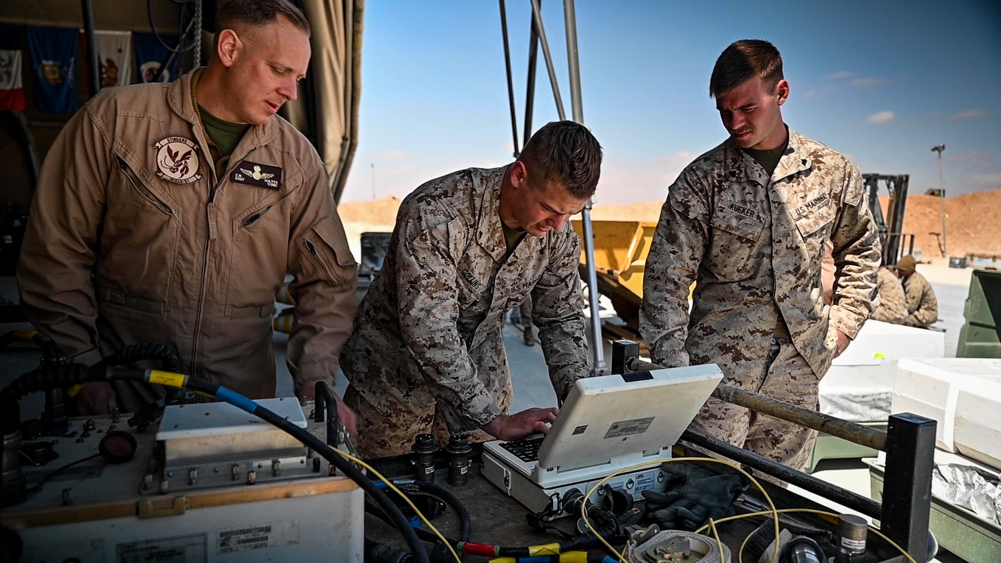 Marine Fighter Attack Squadron 115 aviation ordnance technicians load compatible software for a U. S. Air Force Guided Bomb Unit 38 to be employed on a U.S. Marine Corps F/A-18 Hornet proof of concept mission at an undisclosed location in Southwest Asia, March 14, 2022. VMFA-115 integrated with the 332d Air Expeditionary Wing to further interoperability between the two services by validating ordnance compatibilities between U.S. Air Force and U.S. Marine Corps assets during Operation Agile Spartan II. (U.S. Air Force Photo by Master Sgt. Christopher Parr)