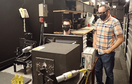 IMAGE: From left to right, Naval Surface Warfare Center Dahlgren Division engineers Ryan Littleton and Michael St. Vincent perform seeker calibration on the semi-active laser (SAL) seeker they helped develop. The new SAL seeker is smaller and lower in cost than previous seekers and will be compatible with the future generations of guided munitions systems.