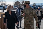 Aman in uniform walks with a woman.