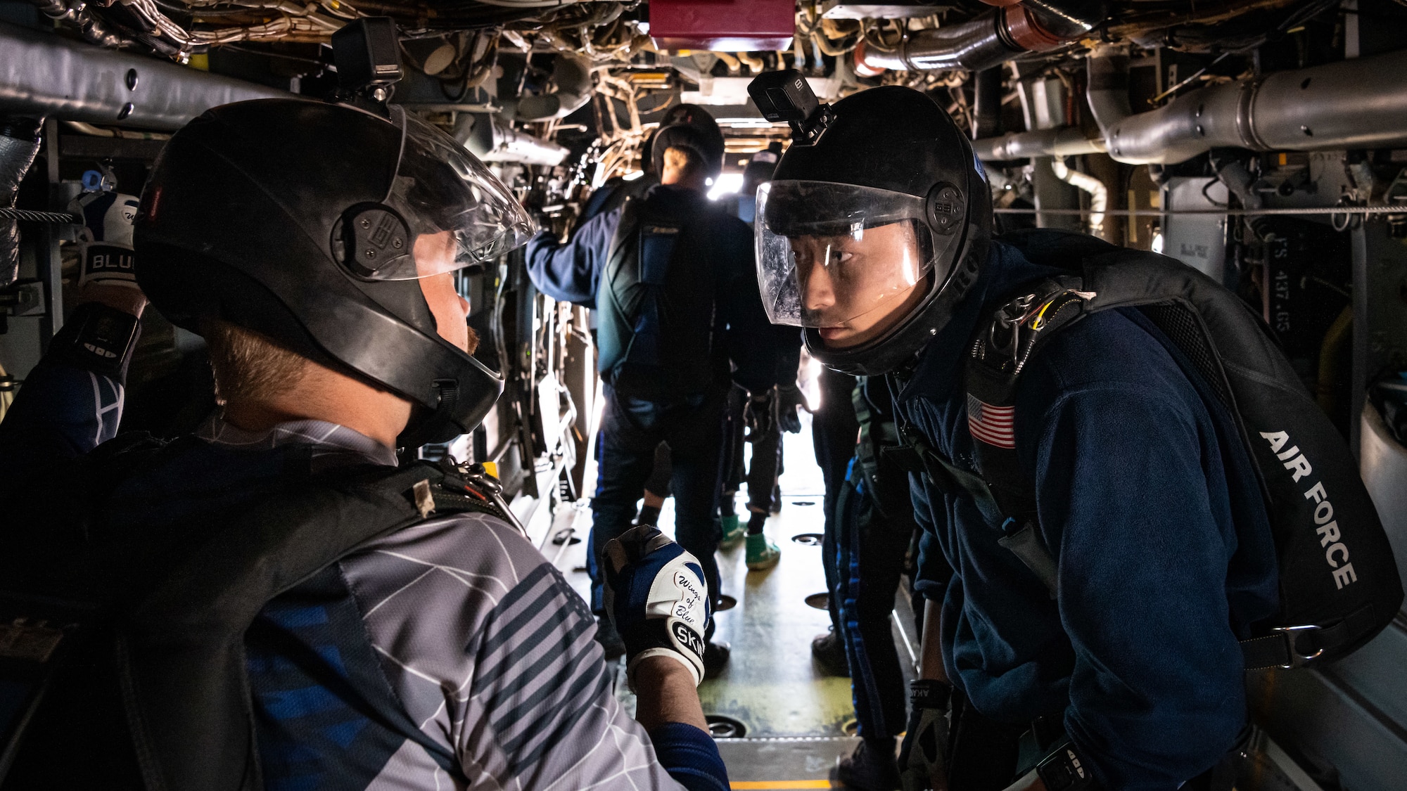 Two Airmen share a look before jumping out of a CV-22 Osprey.