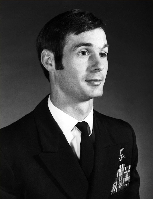 A man in dress uniform poses for a photo.