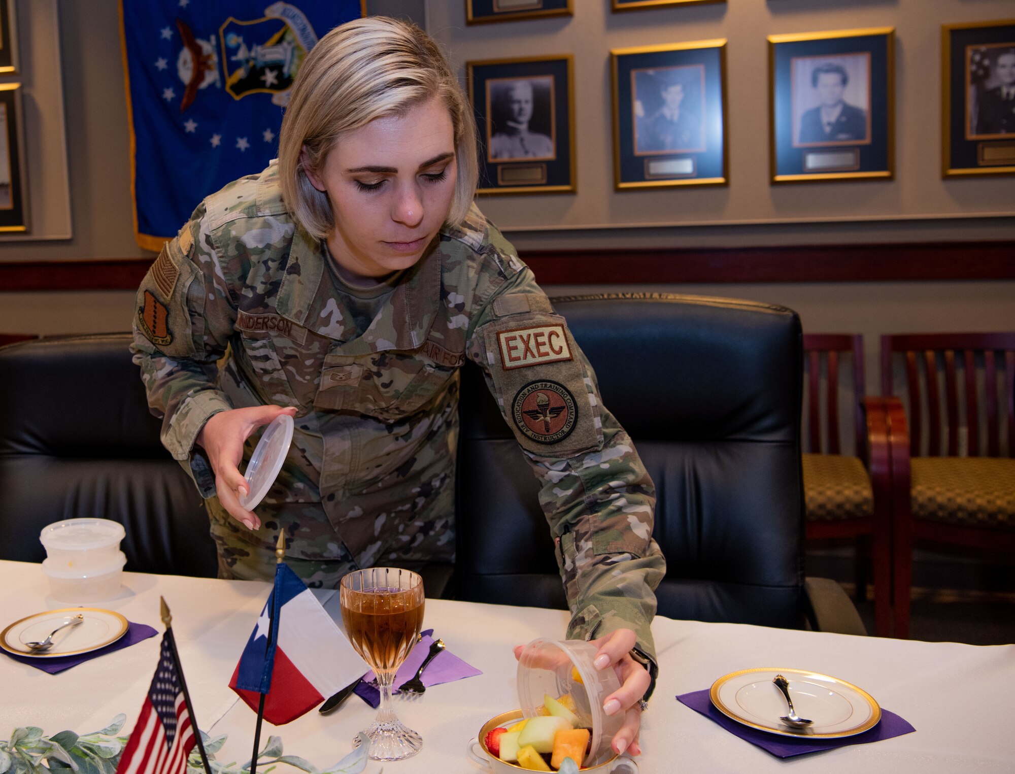 U.S. Air Force Tech. Sgt. Patricia Anderson, 17th Training Wing command chief executive assistant, prepares the table for the 17th Training Wing’s first-ever Gold Star Spouses Day recognition luncheon at Goodfellow Air Force Base, Texas, April 5, 2022. The luncheon honored the spouses of those who made the ultimate sacrifice. (U.S. Air Force photo by Senior Airman Michael Bowman)