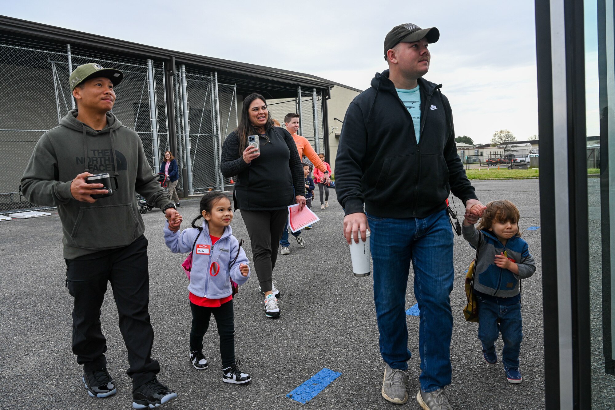 Airmen and their families board a bus to simulate going on a deployment