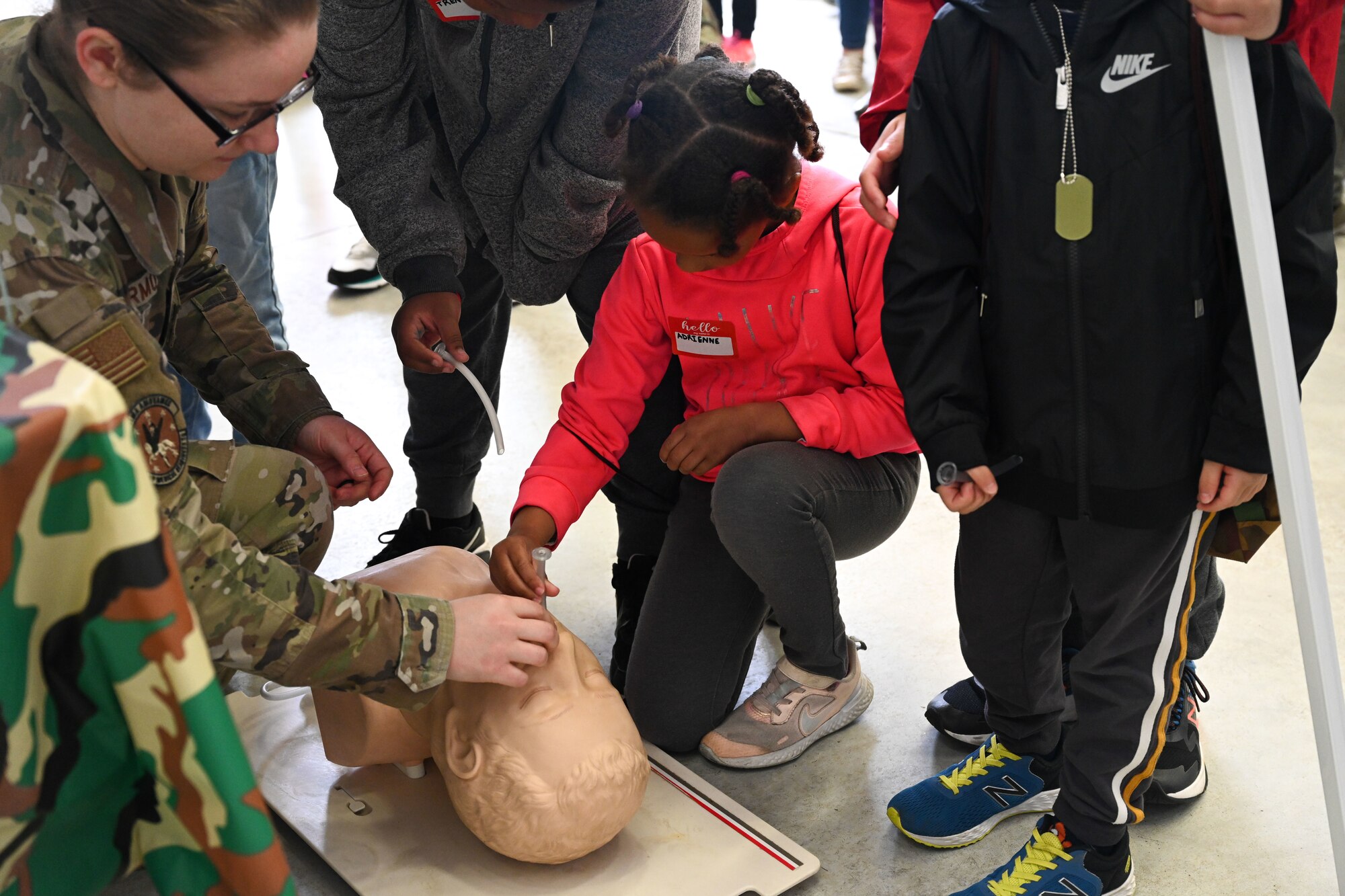 An Airman from the 19th Operational Medical Readiness Squadron gives children a first-aid demonstration