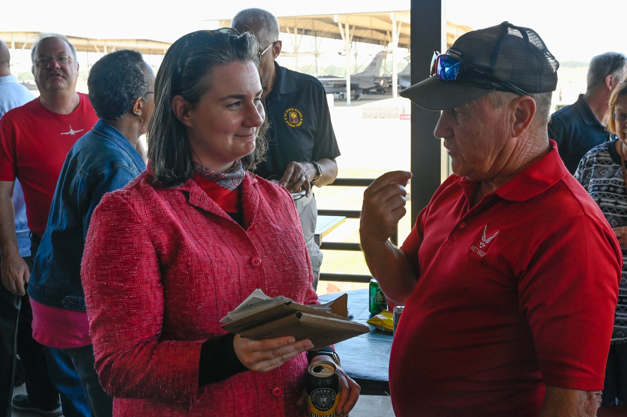 A photo of a historian receiving photos from a veteran
