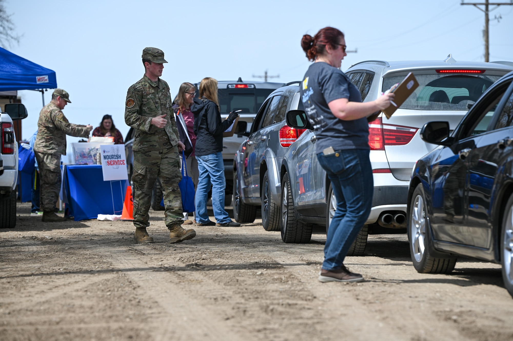 Volunteers load vehicles during a Nourish the Service event at Hill Air Force Base, Utah, April 1, 2022. The event provided new and soon-to-be parents with non-perishable food items, baby care supplies and resource information. (U.S. Air Force photo by R. Nial Bradshaw)