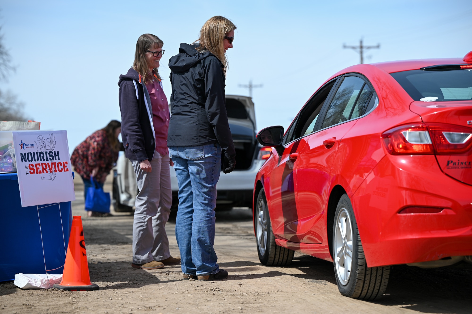 Deedra Nelson, right, and Nicola Olsen, with Hill's New Parent Support Program, speak with families during a Nourish the Service event at Hill Air Force Base, Utah April 1, 2022. The event provided new and soon-to-be parents with non-perishable food items, baby care supplies and resource information. (U.S. Air Force photo by R. Nial Bradshaw)