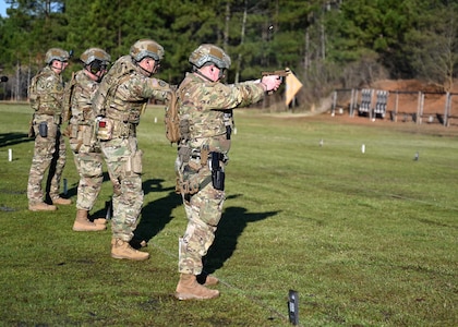 From left, Staff Sgt. Joseph Wyner, Tech. Sgt. Michael Strempfer, Staff Sgt. David Fostier, and Capt. Patrick Randall of New Hampshire National Guard's "Team Alpha" blaze through a pistol match during the 51st Winston P. Wilson Pistol and Rifle Championships on March 31, 2022, at Camp Robinson, Ark.