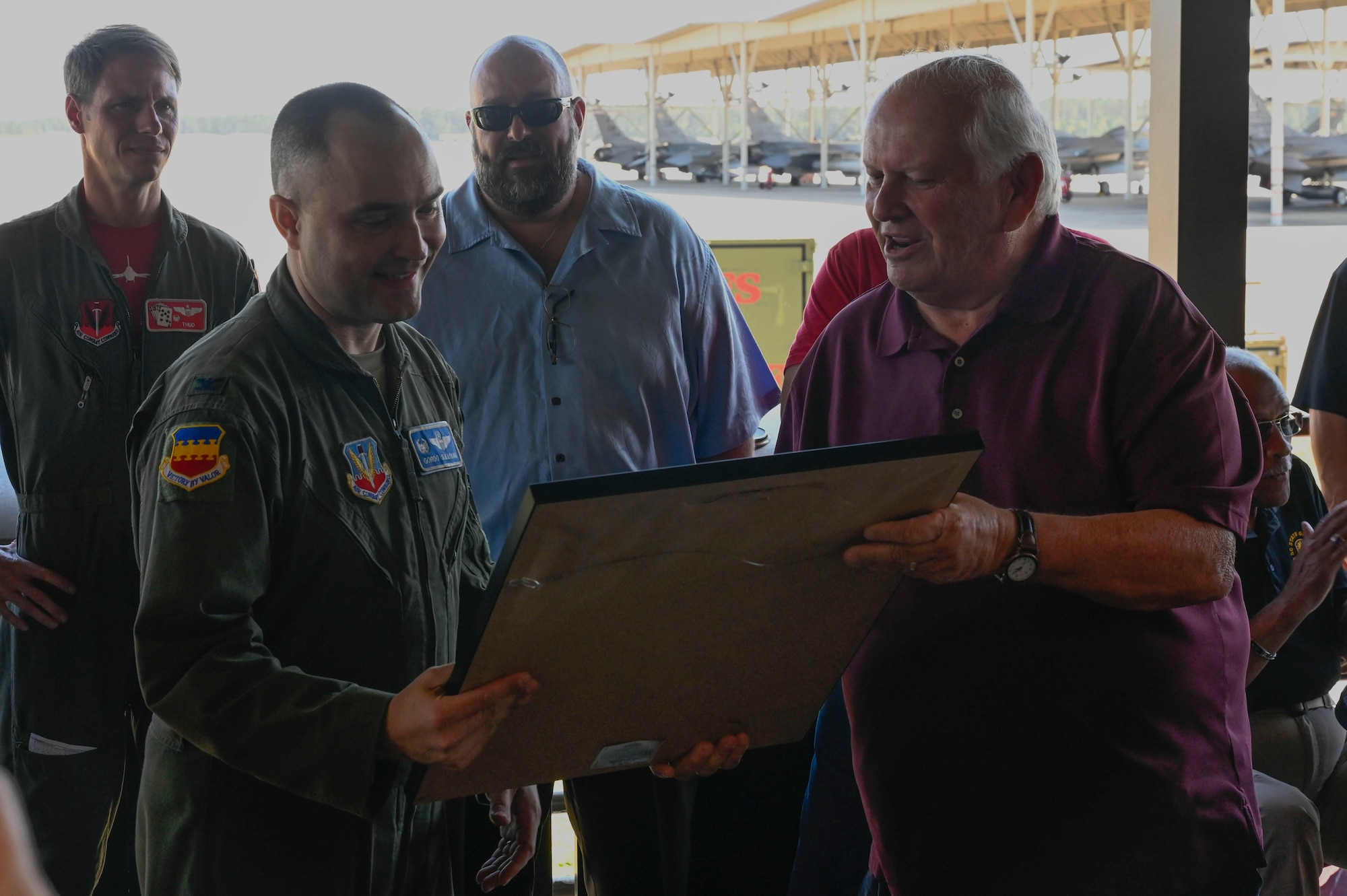 A photo of a U.S. Air Force leader receiving a gift from a veteran