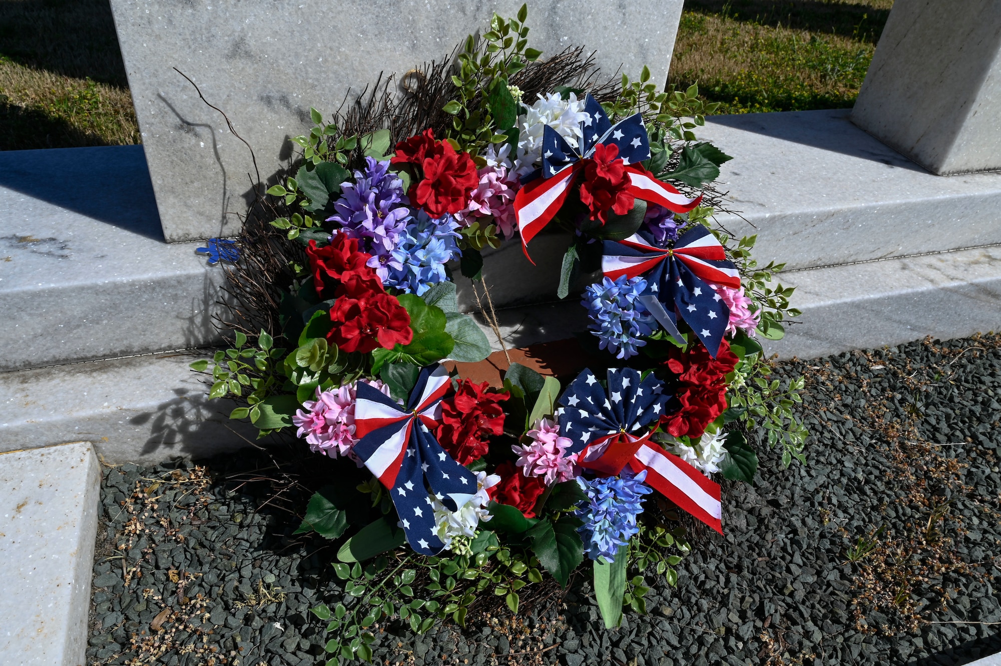 A photo of a wreath laying on a monument