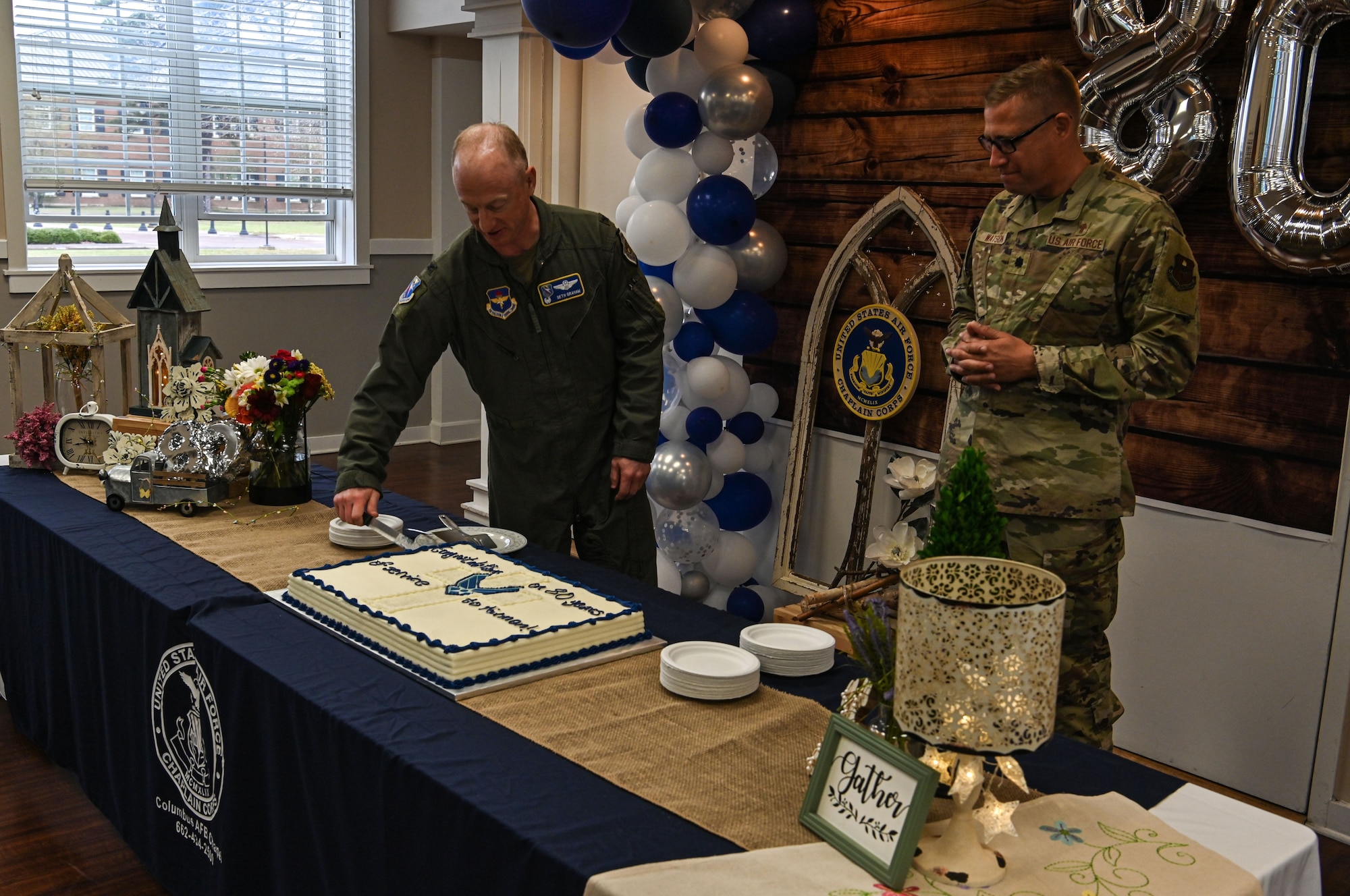 Col. Seth Graham, 14th Flying Training Wing commander cuts a cake to commemorate the 80th anniversary of the Columbus Air Force Base Chapel on April 5, 2022, at Columbus AFB, Miss. The mission of the Columbus AFB Chapel is to “Develop Spiritually Strong Airmen and Families”. (U.S. Air Force photo by Senior Airman Davis Donaldson)